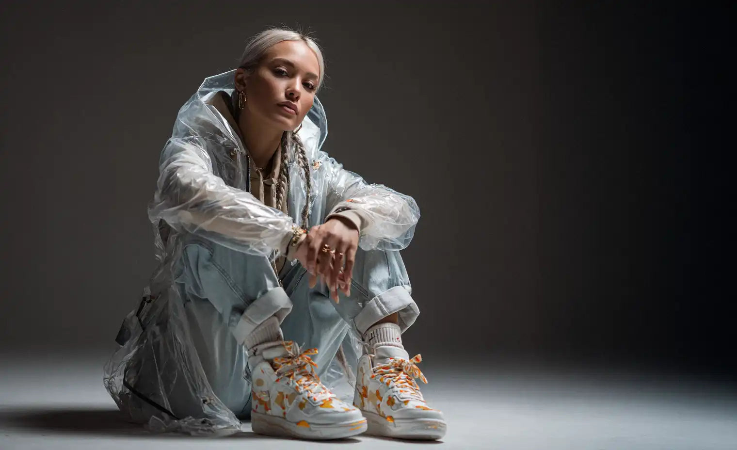 woman in a transparent windbreaker in y2k style