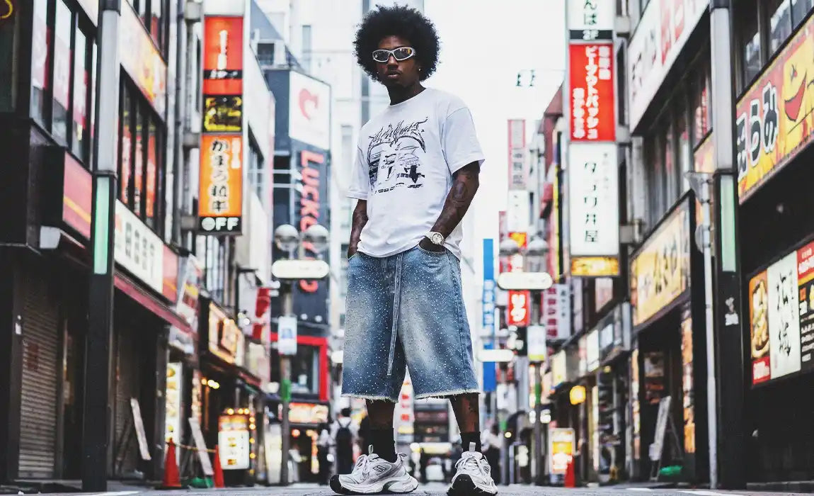 A black man in a streetwear outfit featuring rhinestone jorts