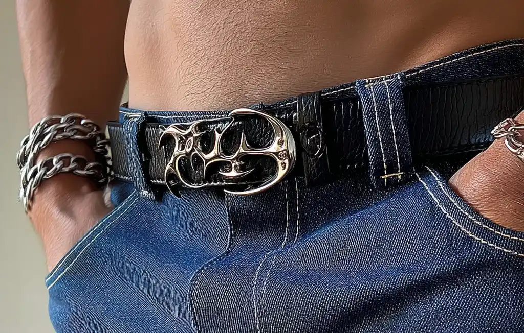 Classic black y2k belt with metallic studs and silver buckle, worn with black jeans.