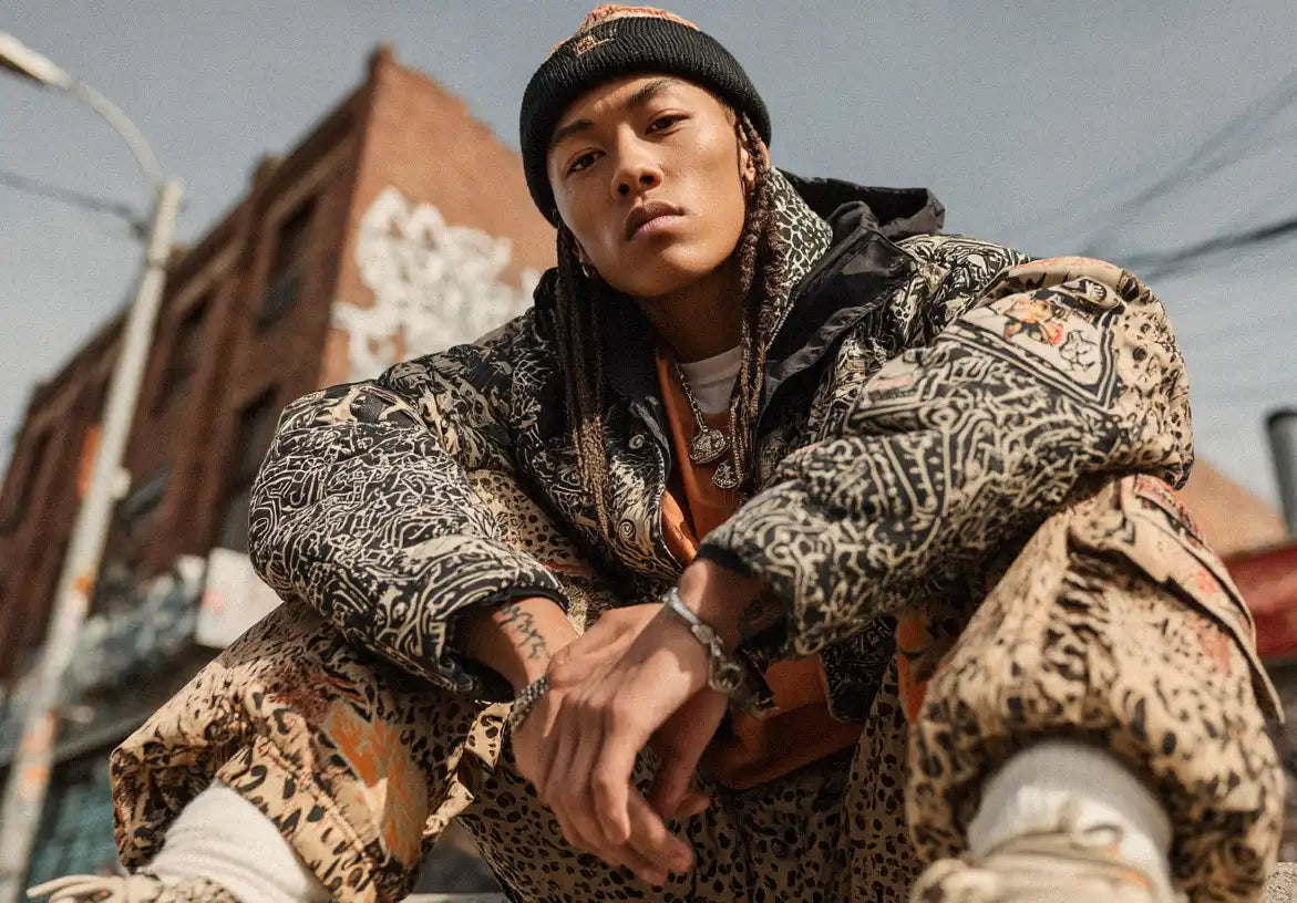 Close-up of model in patterned puffer and cargo pants, serving gritty Y2K street fashion.